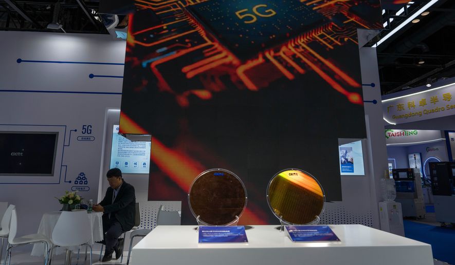 A man rests at the booth for Chinese DRAM producer ChangXin Memory Technologies, also known as CXMT, during the 21st China International Semiconductor Expo in Beijing, Nov. 20, 2024. (AP Photo/Ng Han Guan, File)