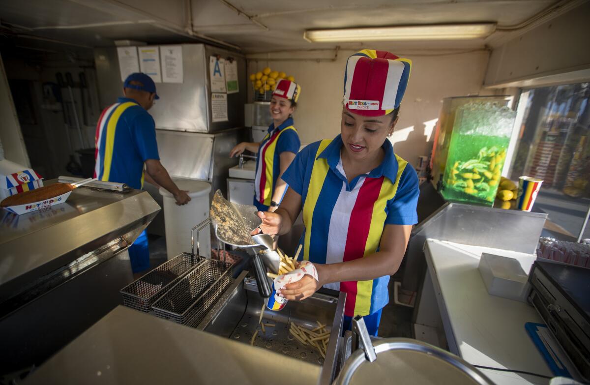 Employees at Hot Dog on a Stick on the boardwalk near the Santa Monica pier. 
