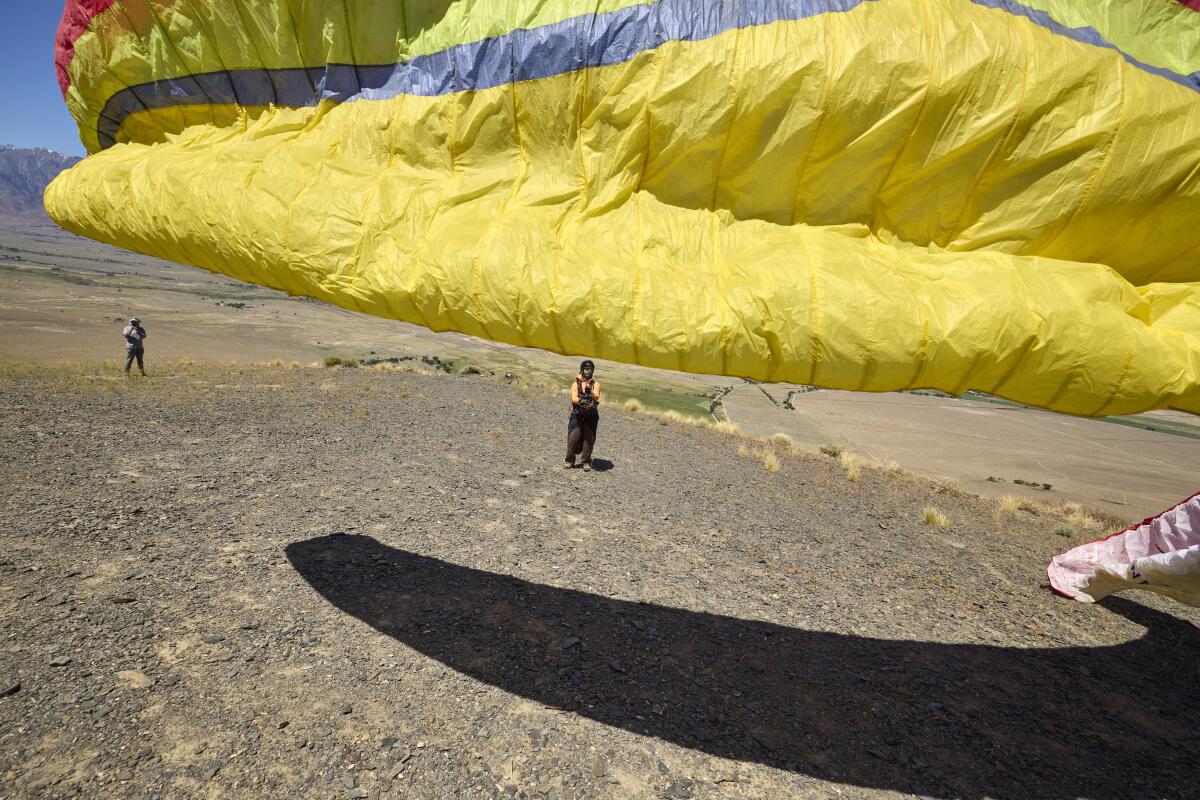 Kari Castle gets ready to launch her paraglider.
