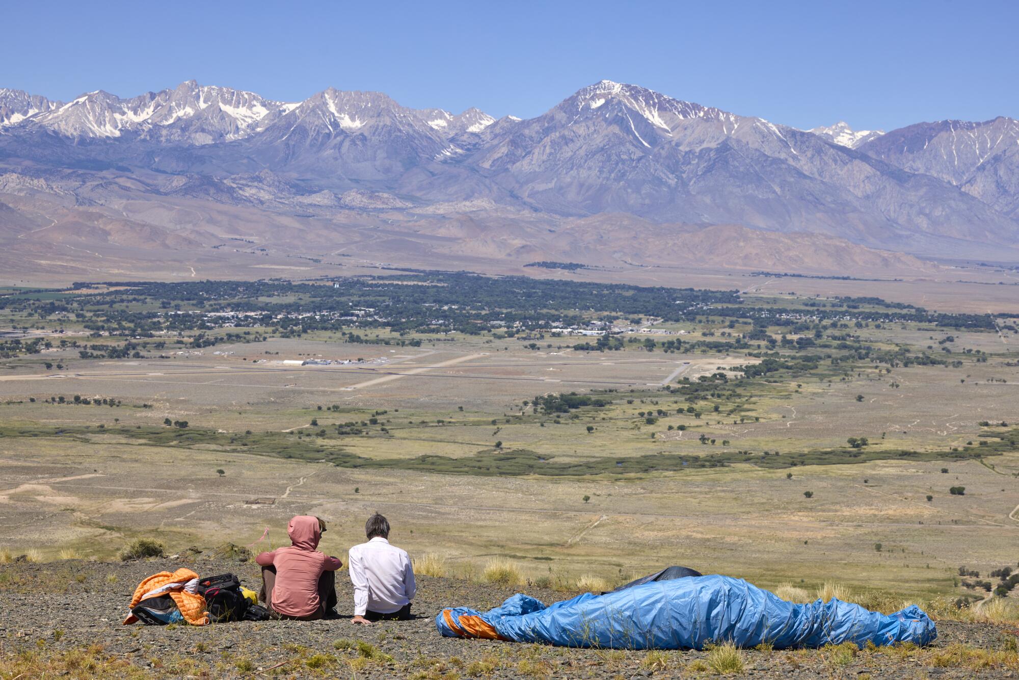 Barry Smith, right, and Kari Castle take a moment at the launch point above the Owen's Valley.