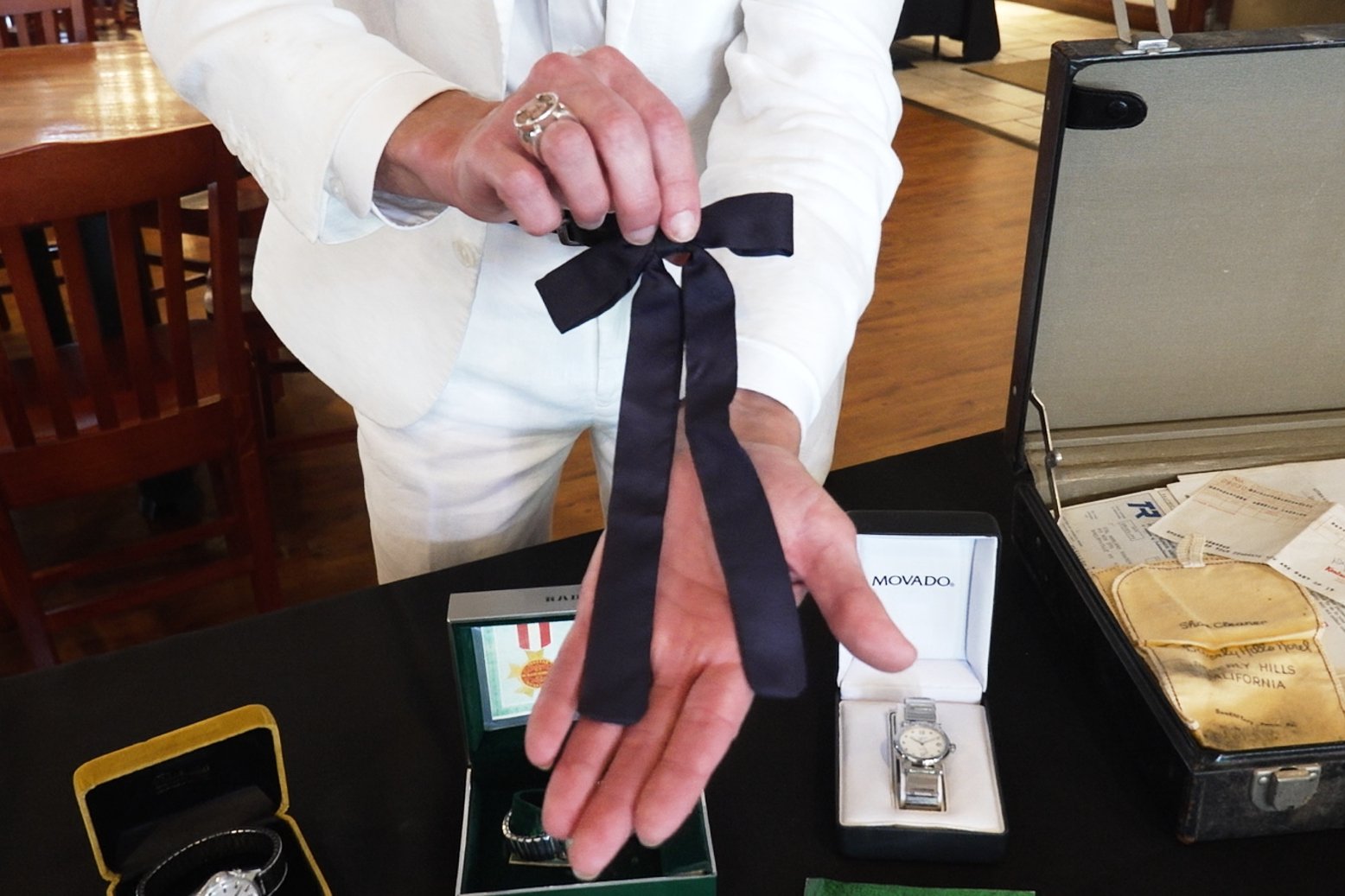Auctioneer Jonathan Klunk shows a black bow tie worn by KFC founder