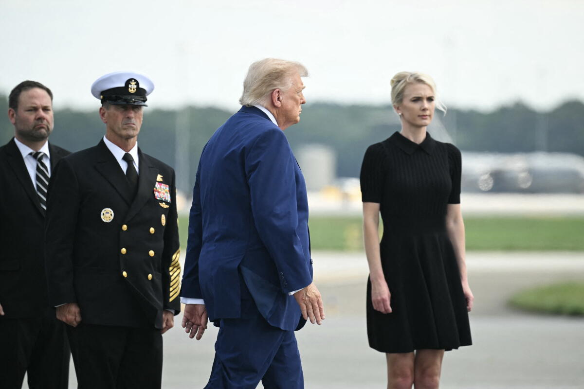 President Trump and Natalie Harp, right, attend a dignified transfer