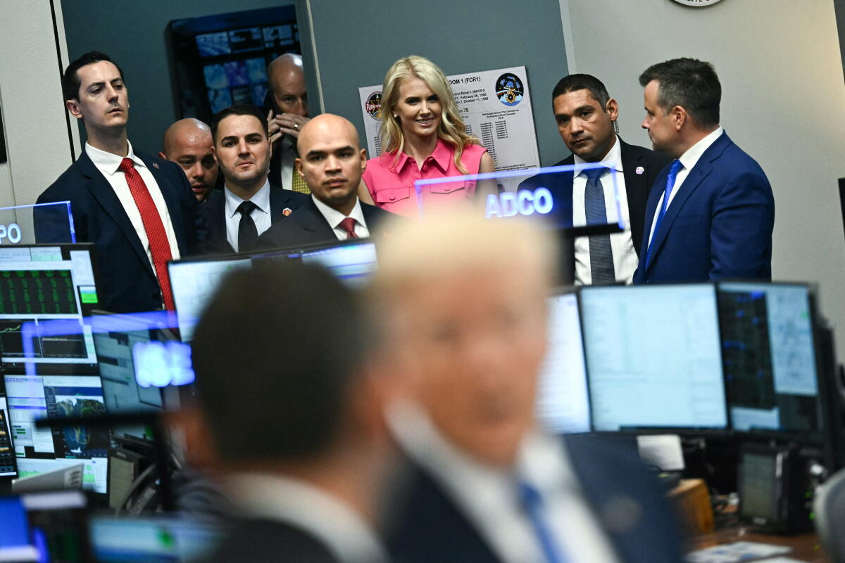 Natalie Harp looks on as President Trump visits the Mission Control Center at NASA