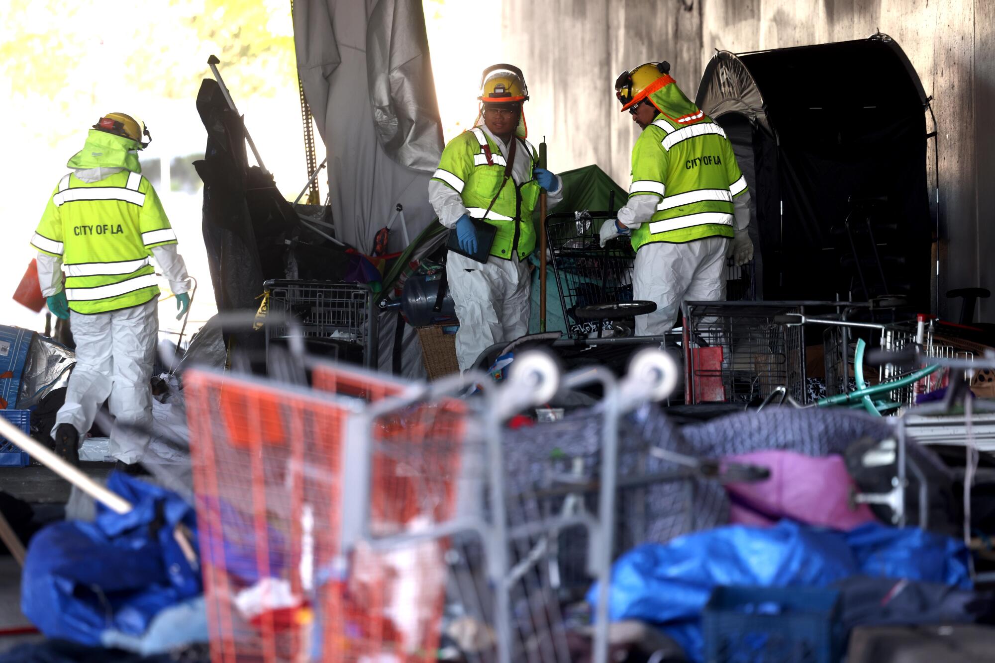 Sanitation crews gather belongings from a homeless encampment during an Inside Safe operation in North Hollywood in March.