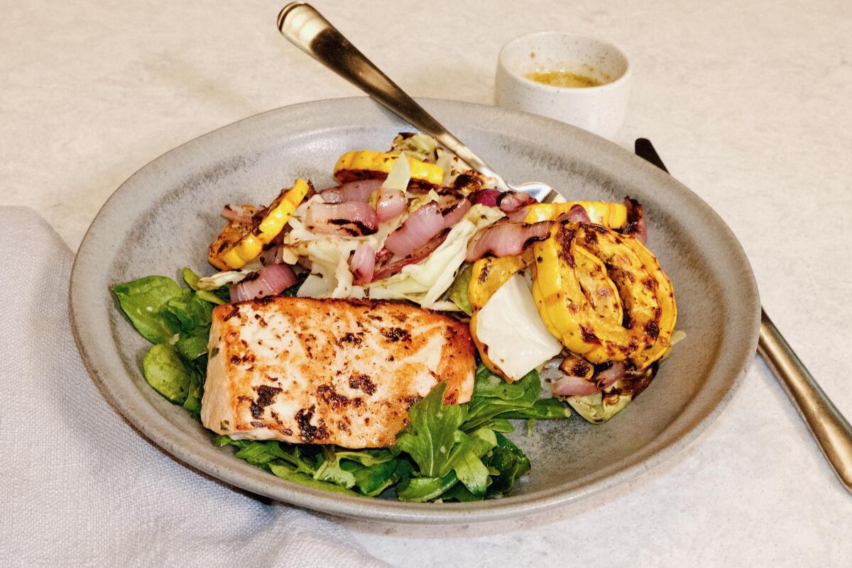 Goop Kitchen executive chef Kim Floresca prepares a winter salmon bowl in the L.A. Times Test Kitchen.