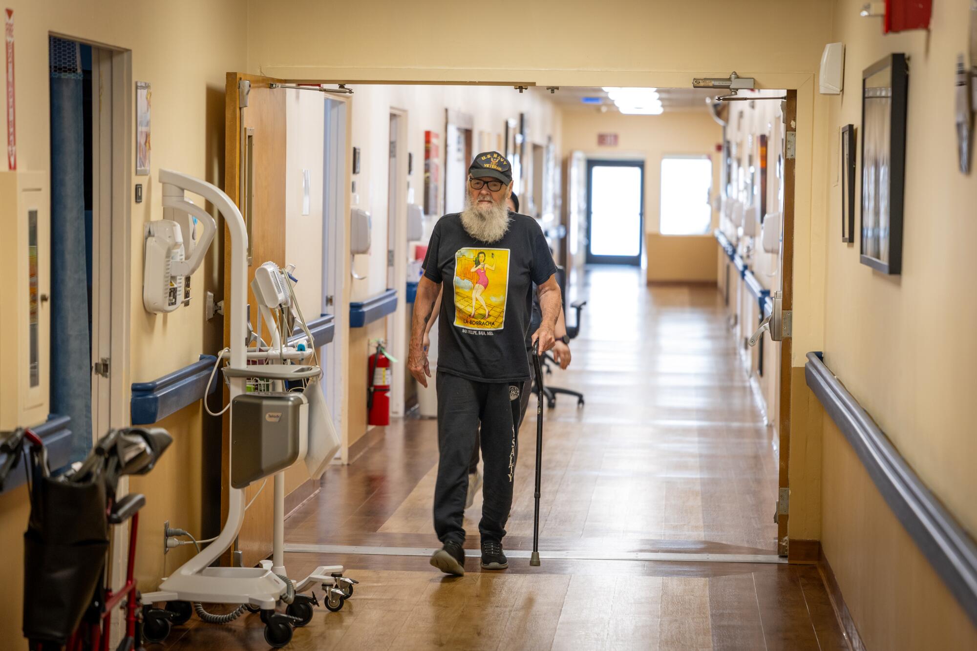 Long-term patient Don Cisell walks to his room at Catalina Island Health.