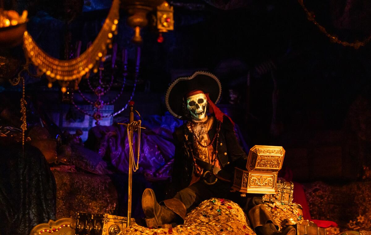 A skeleton pirate holds a piece of gold.