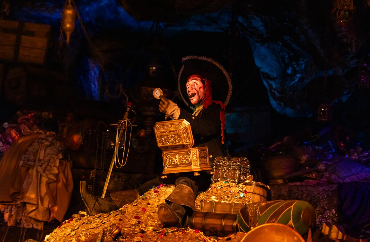 A pirate figure holds a piece of gold