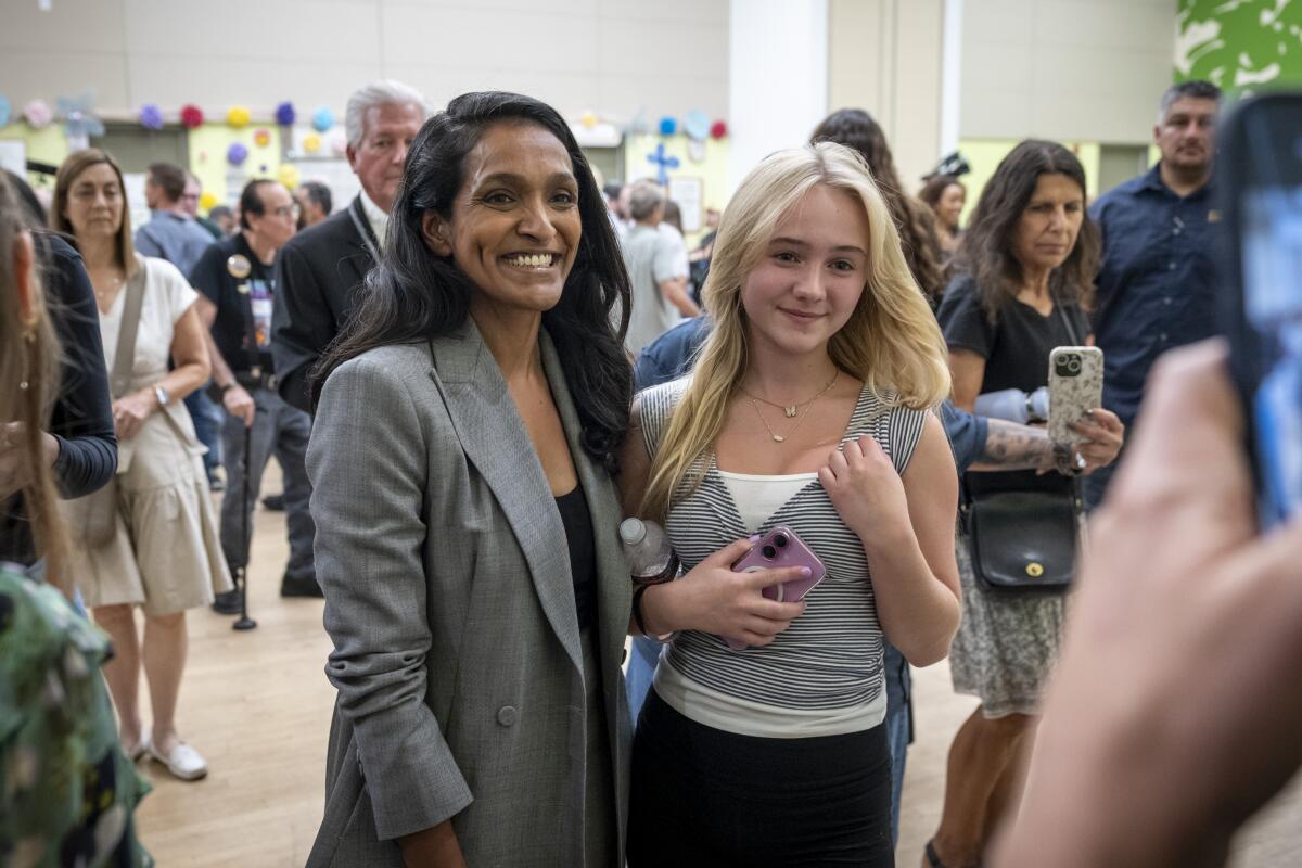 Nithya Rama speaks with staff and supporters just after the end of the debate. 