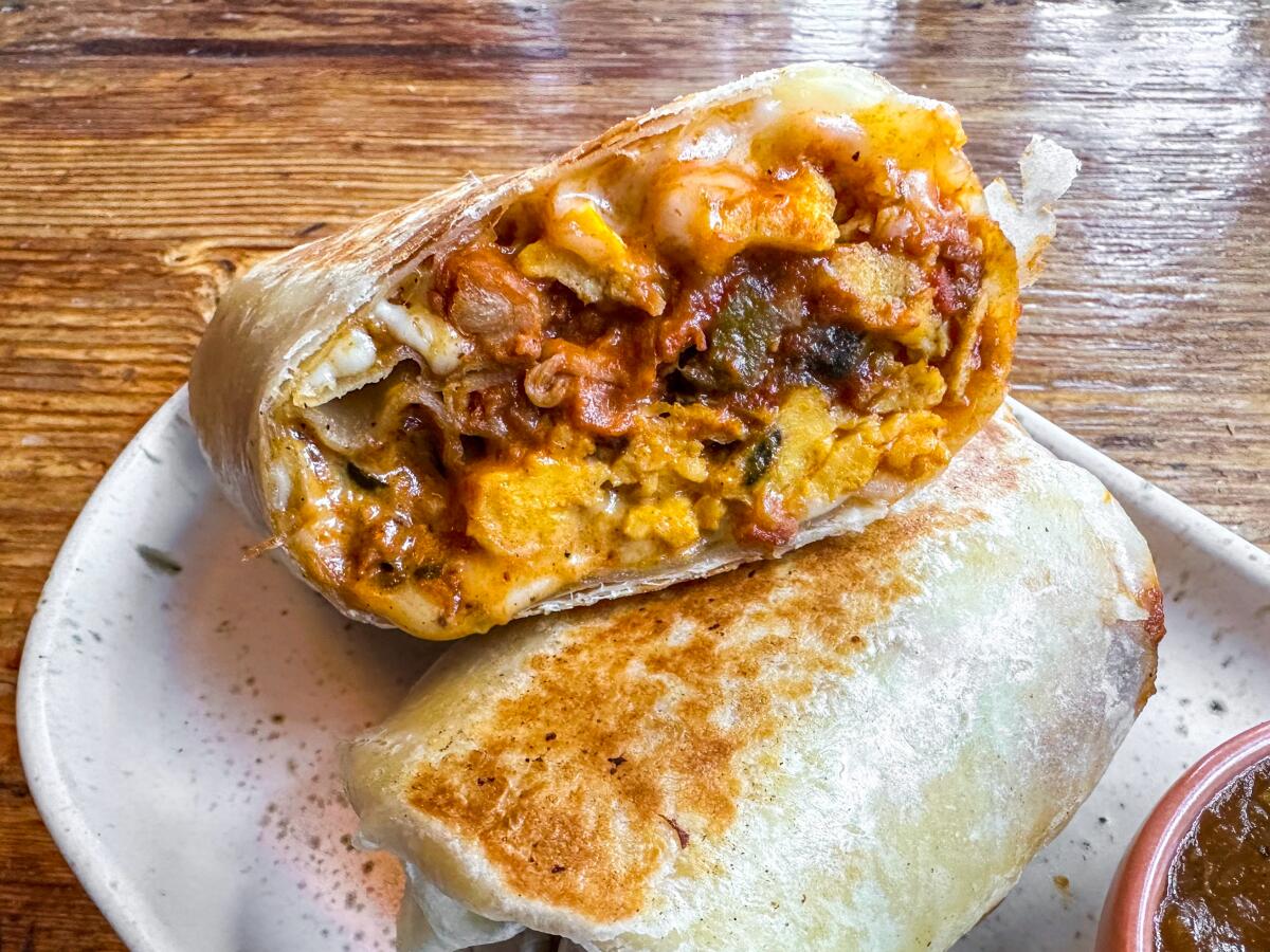 A breakfast burrito filled with machaca and shrimp.