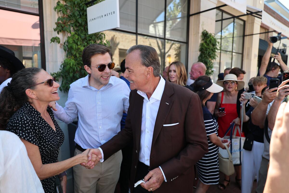 Developer Rick Caruso greets crowd members attending the grand reopening.