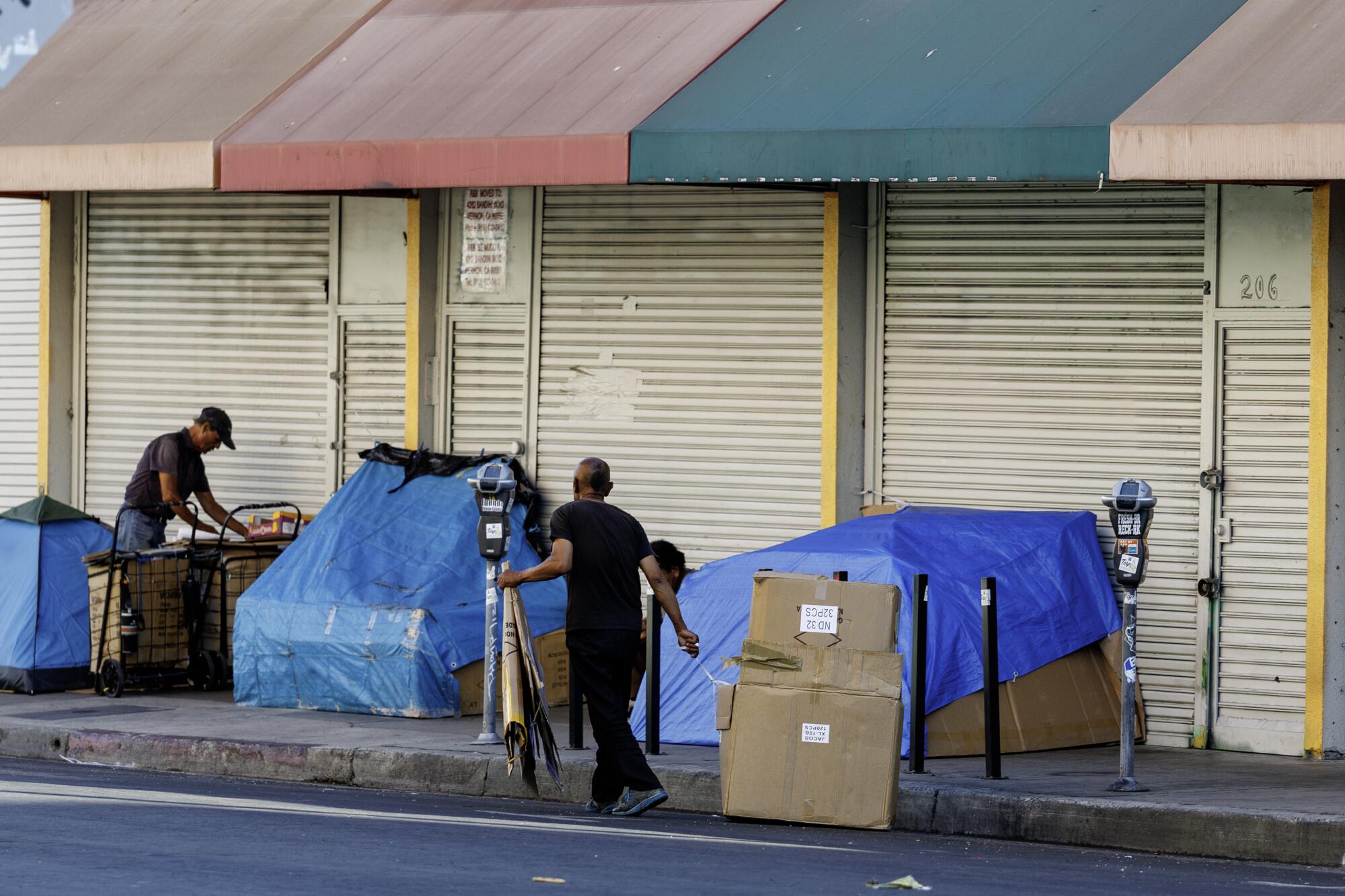 People living on the street gather cardboard for shelter.