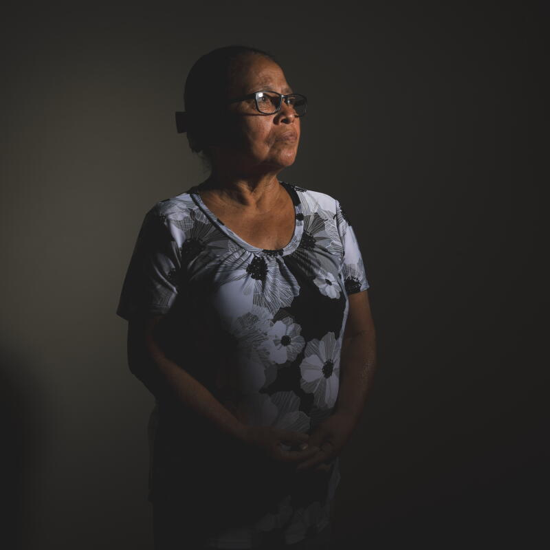 A woman stands for a portrait.