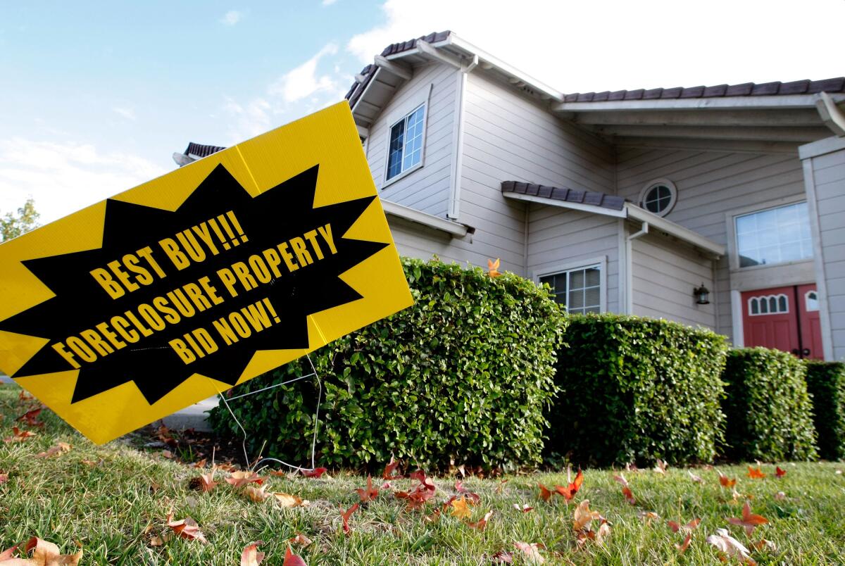 A foreclosure sale sign in front of a home
