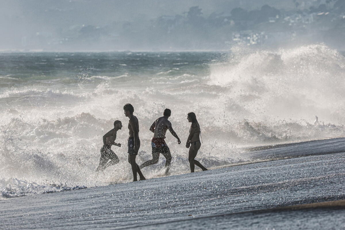 Beachgoers frolic in the ocean at Zuma Beach in Malibu 