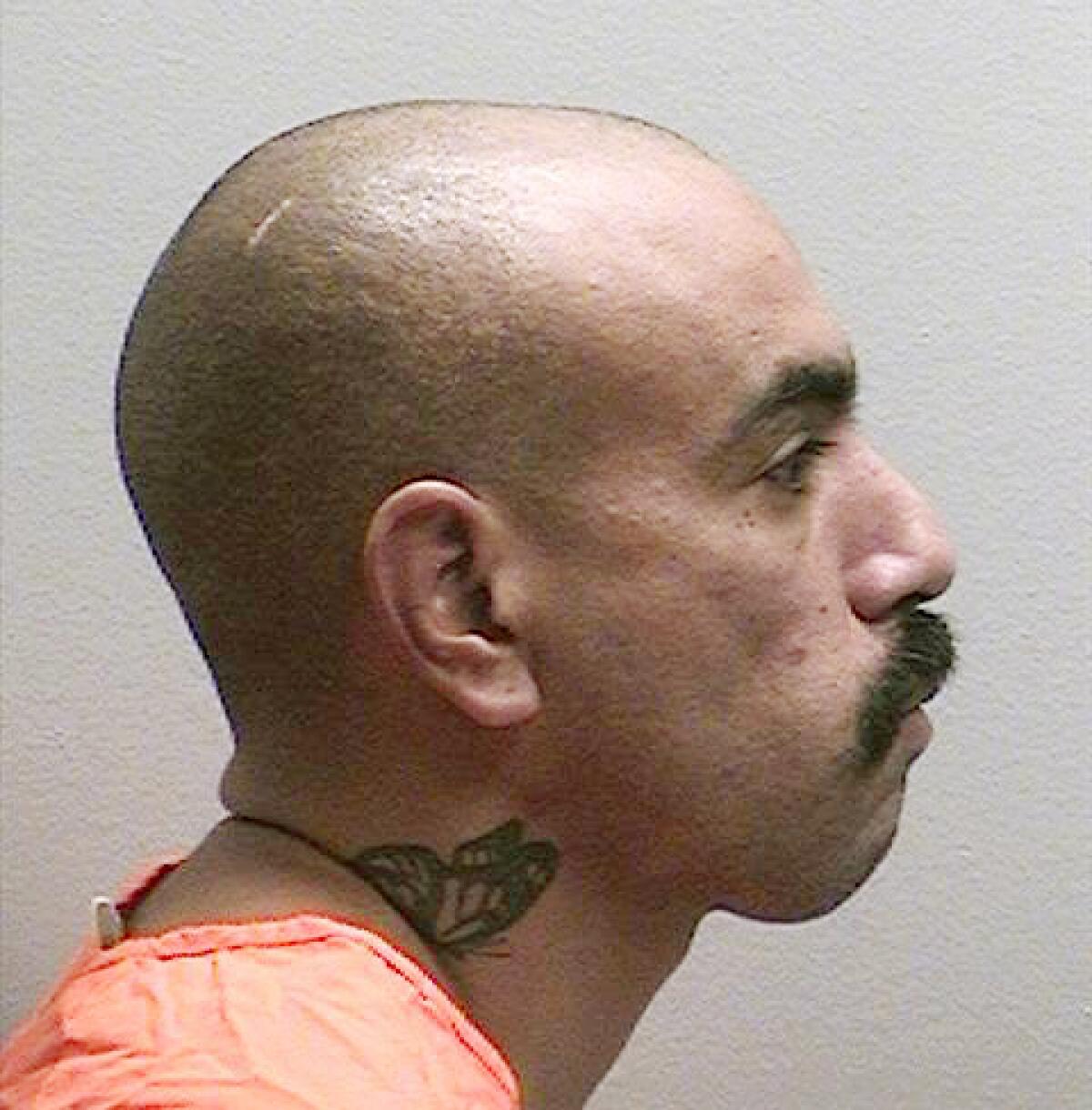 Ezequiel Romo tattoed a butterfly, a symbol of the Mexican Mafia, on his neck.