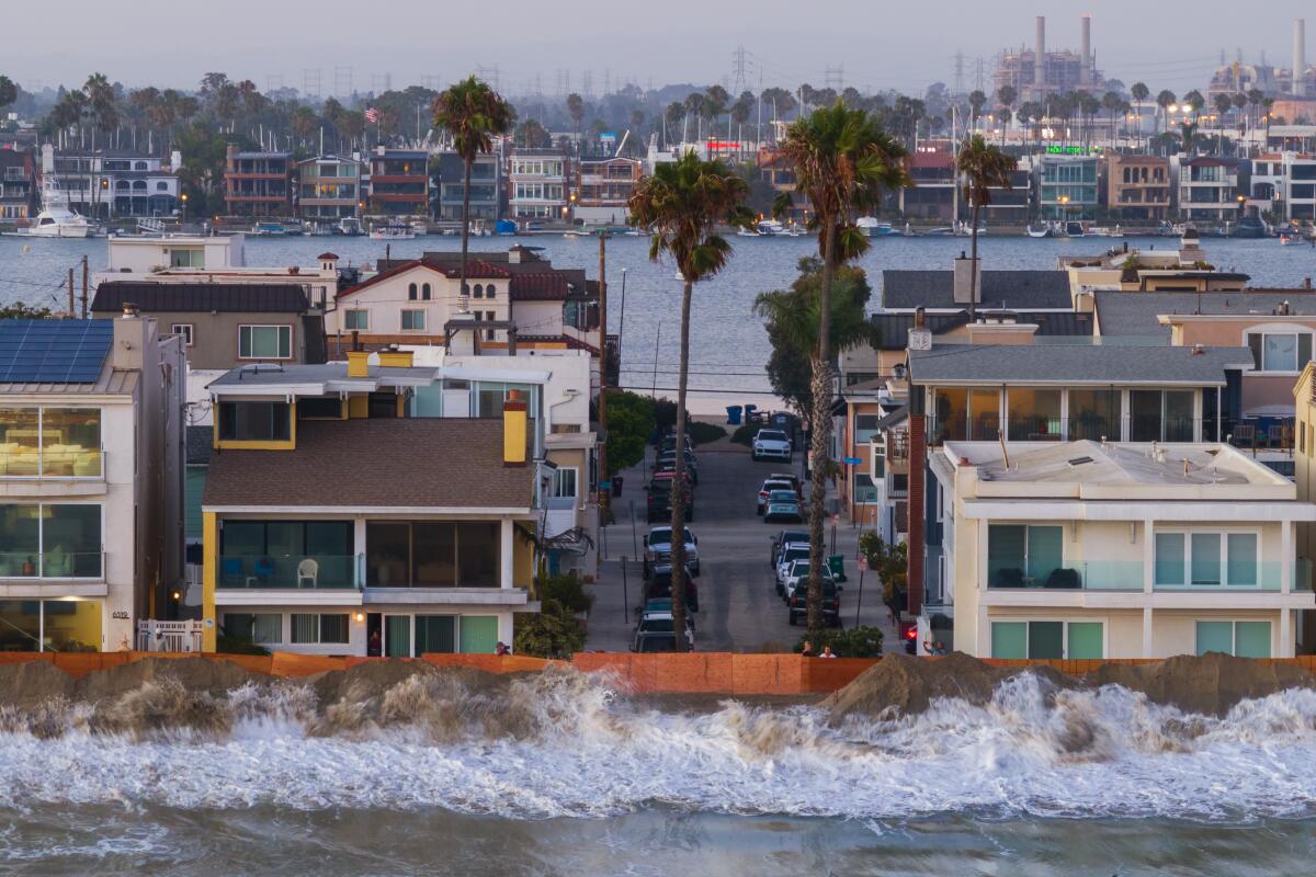  Long Beach city workers prepare a sand brim to prevent flooding due to high tide and strong surf at the Penisula.