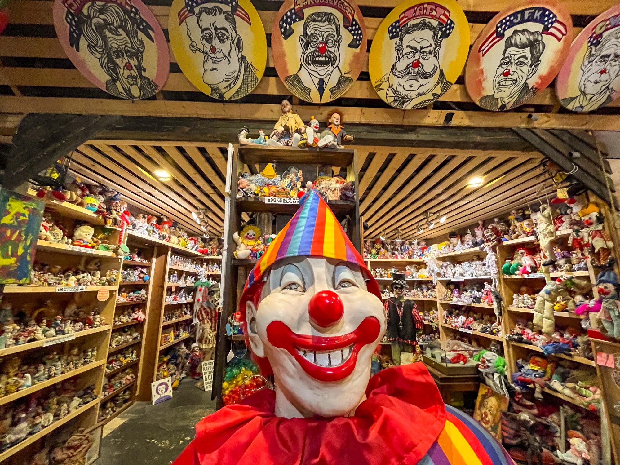 A large clown face in the foreground of several clown faces at Tonopah's Clown Motel