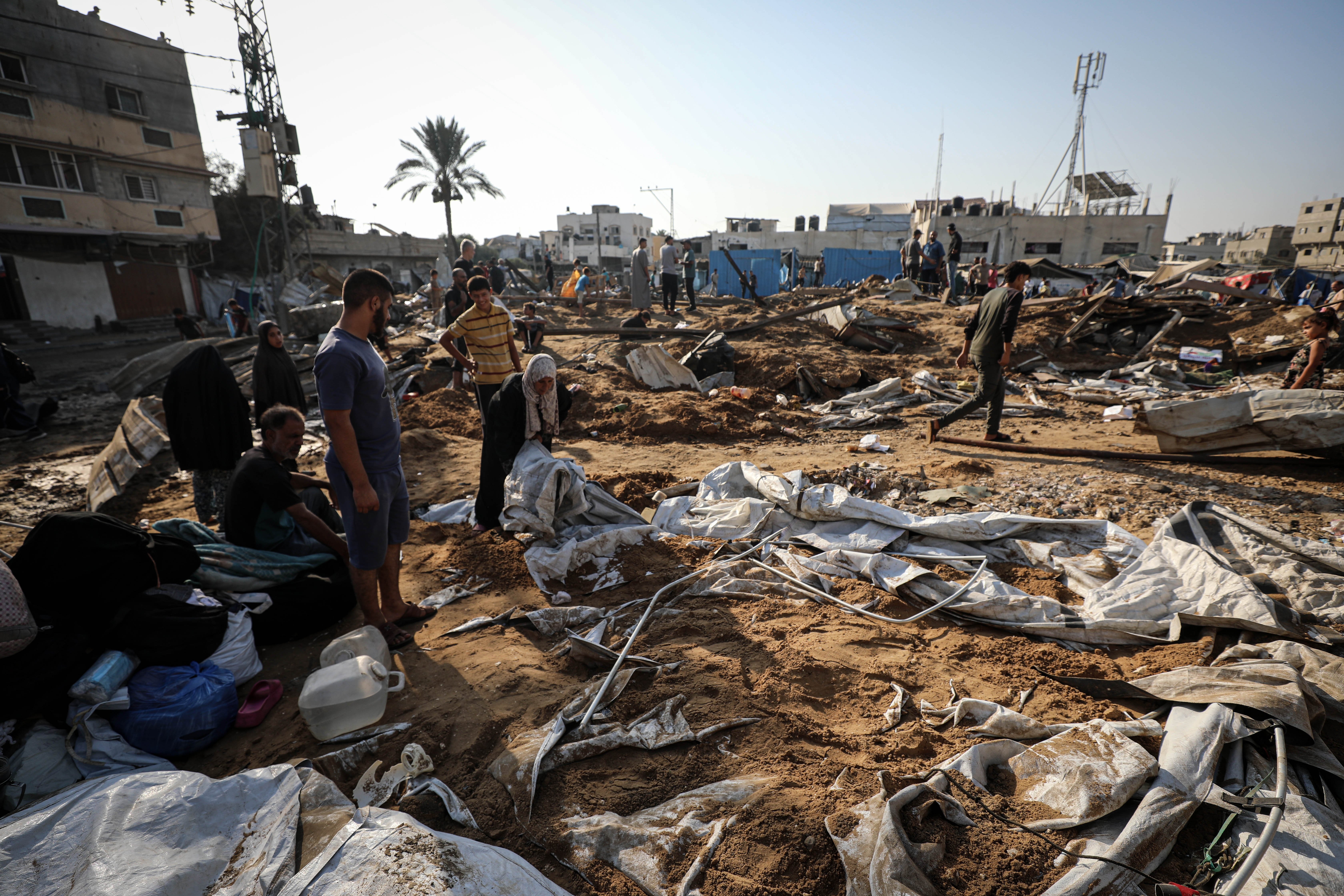 Displaced Palestinians inspect the destruction following an Israeli airstrike that targeted the nearby medical supplies and pharmaceuticals warehouse of Al-Aqsa Martyrs Hospital, in Deir al-Balah, central Gaza Strip on August 1, 2026. Hamas said on July 31, 2026, it had agreed to a deal that includes handing over its weapons to a Palestinian governing committee and the gradual withdrawal of Israeli forces from the Gaza Strip. Israel has yet to officially comment on the announcement. (Photo by Majdi Fathi/NurPhoto via Getty Images)