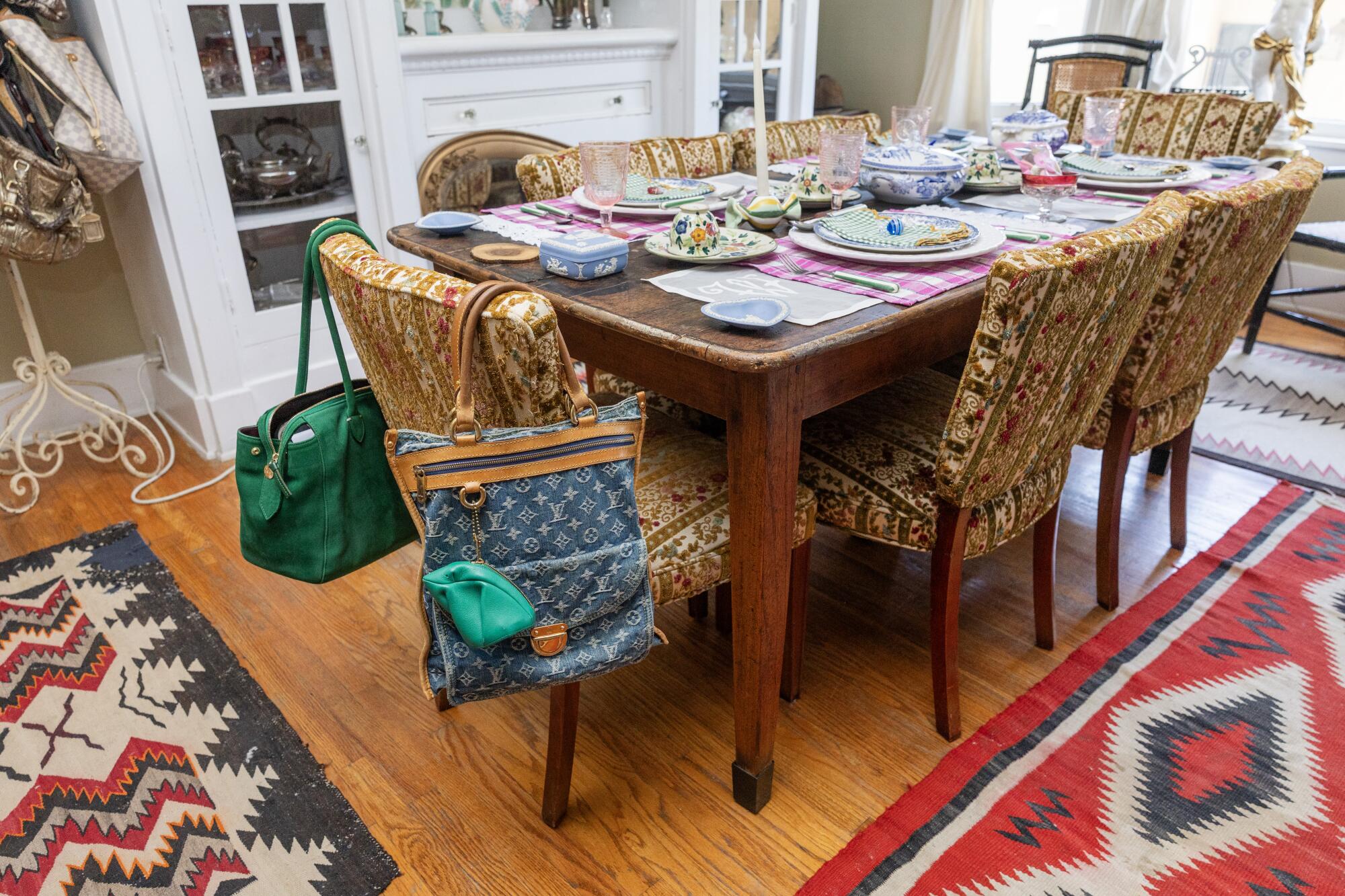 Handbags are draped over dining chairs.