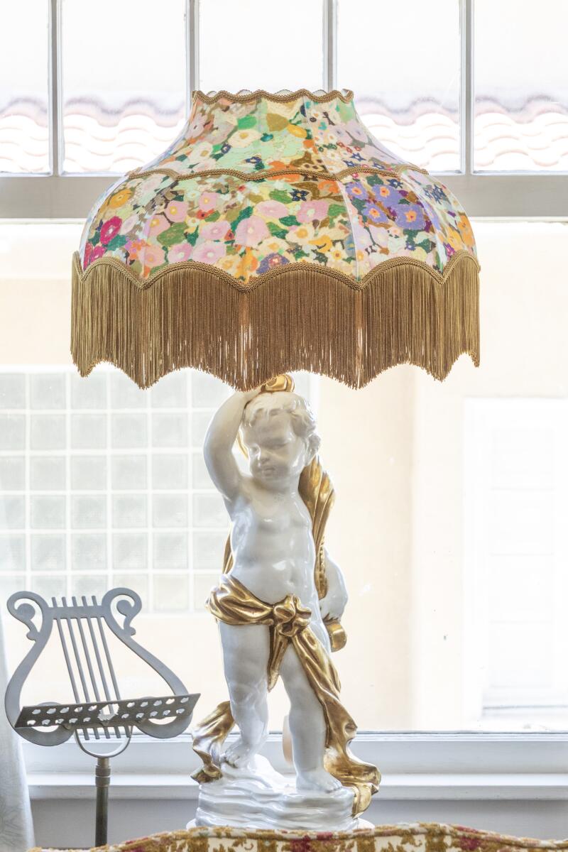 A white cherub lamp with a colorful House of Hackney fabric lampshade. 