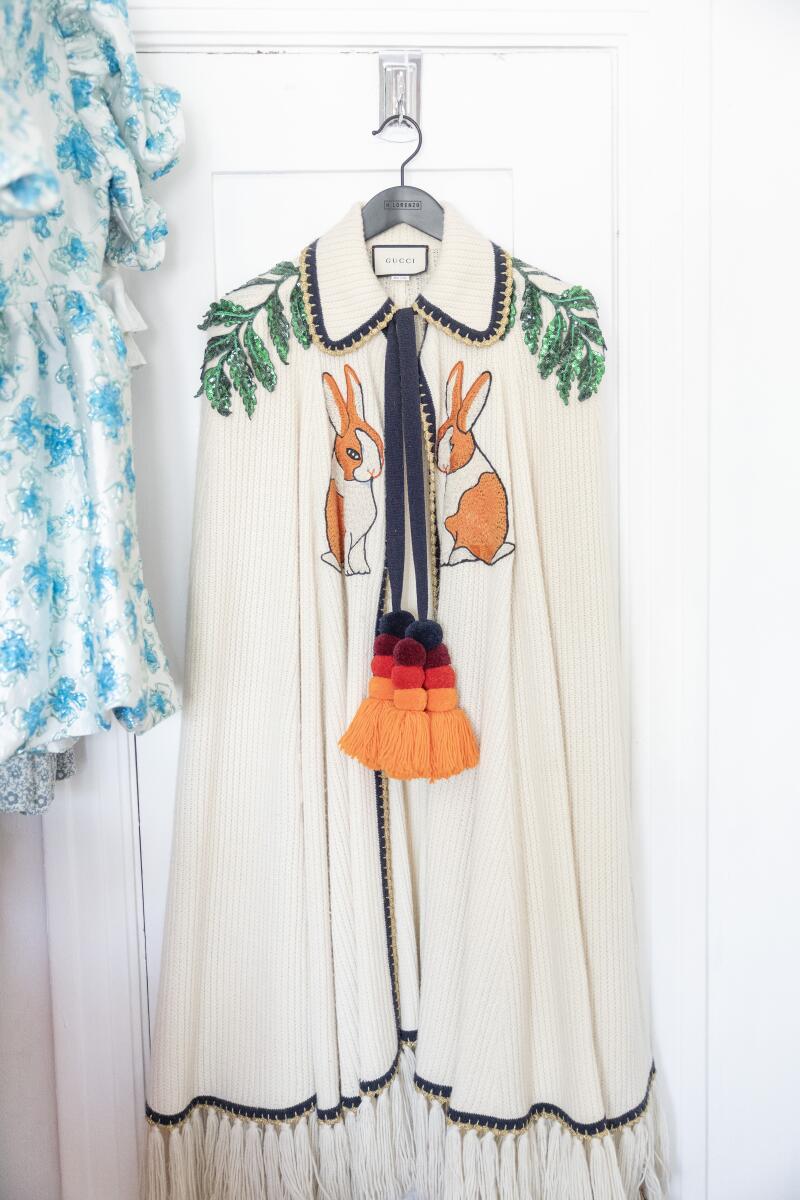 A Gucci bunny cape hangs in a bedroom.