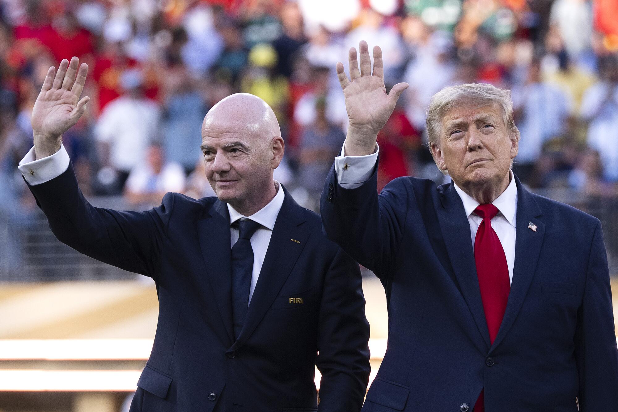 FIFA president Gianni Infantino, left, and President Trump wave during an award ceremony.