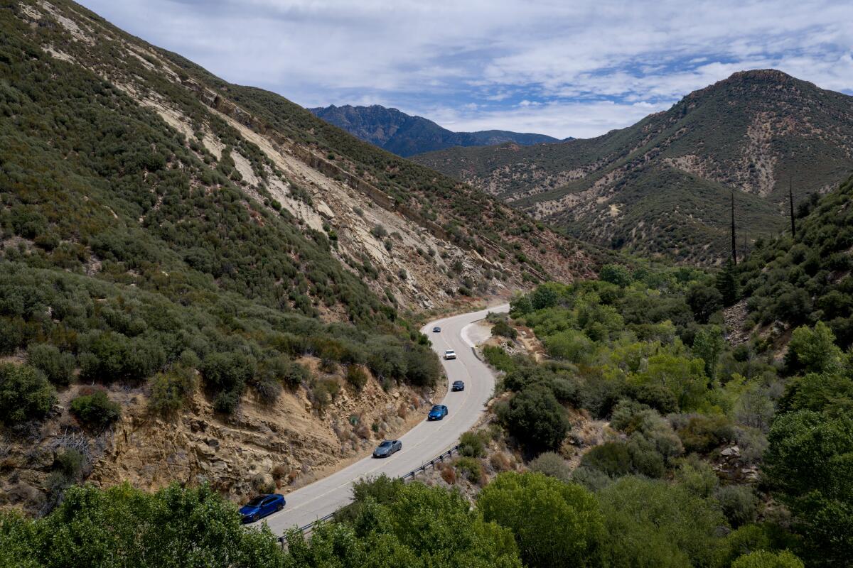 A group of friends drive their cars along State Route 33 near Ojai
