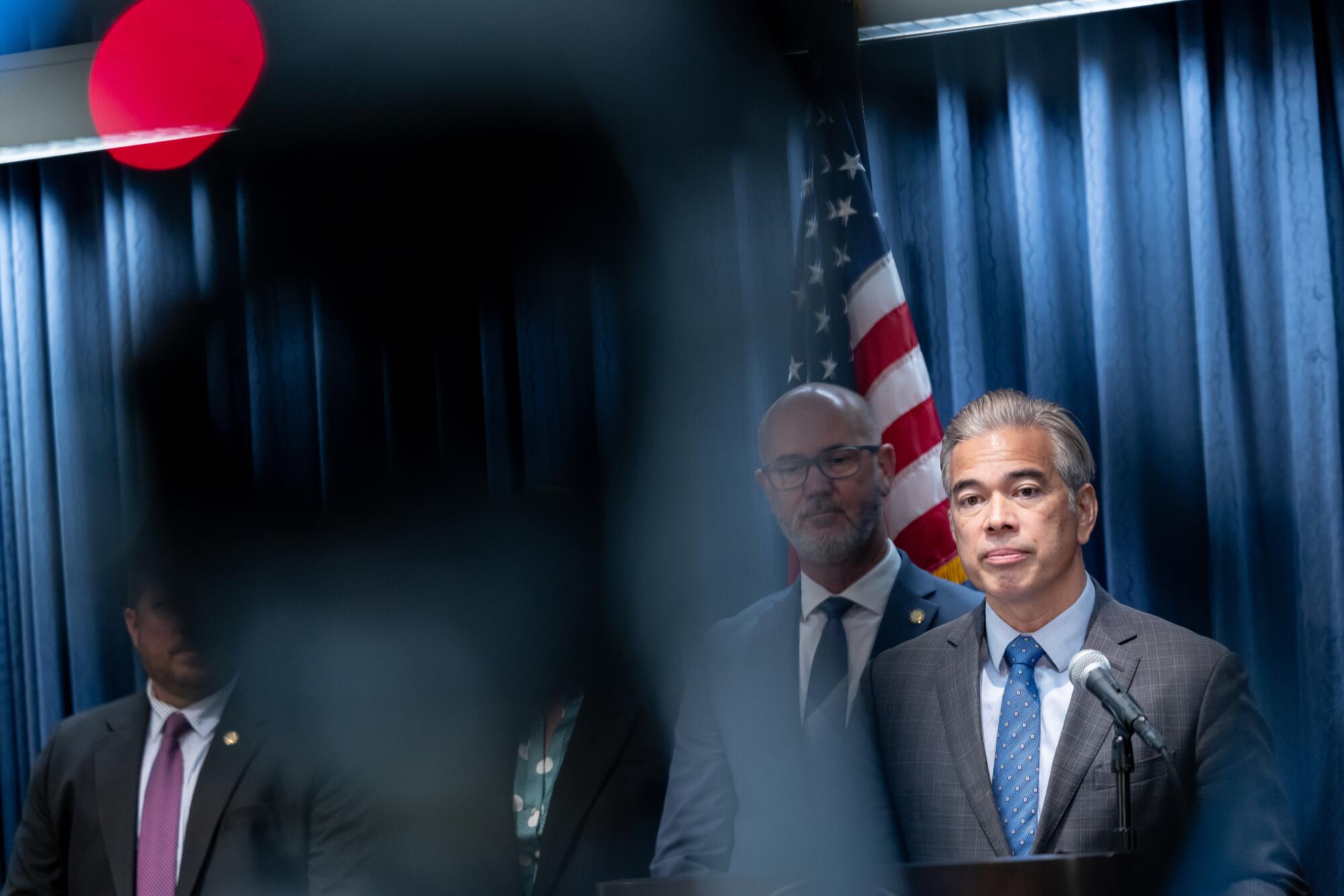 California Attorney General Rob Bonta, right, holds a press conference