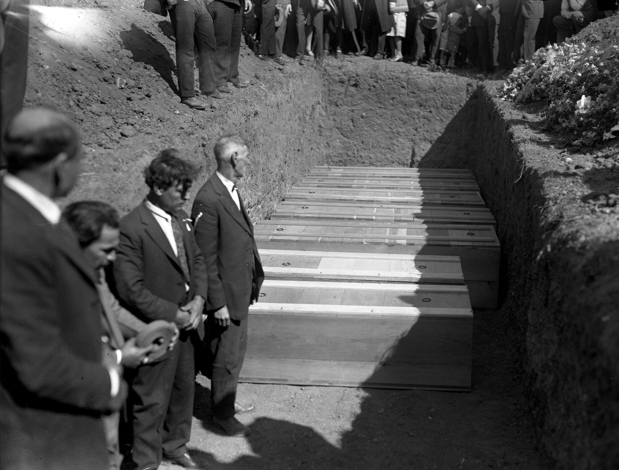 Seven coffins containing victims of the 1928 St. Francis Dam collapse are prepared for burial.