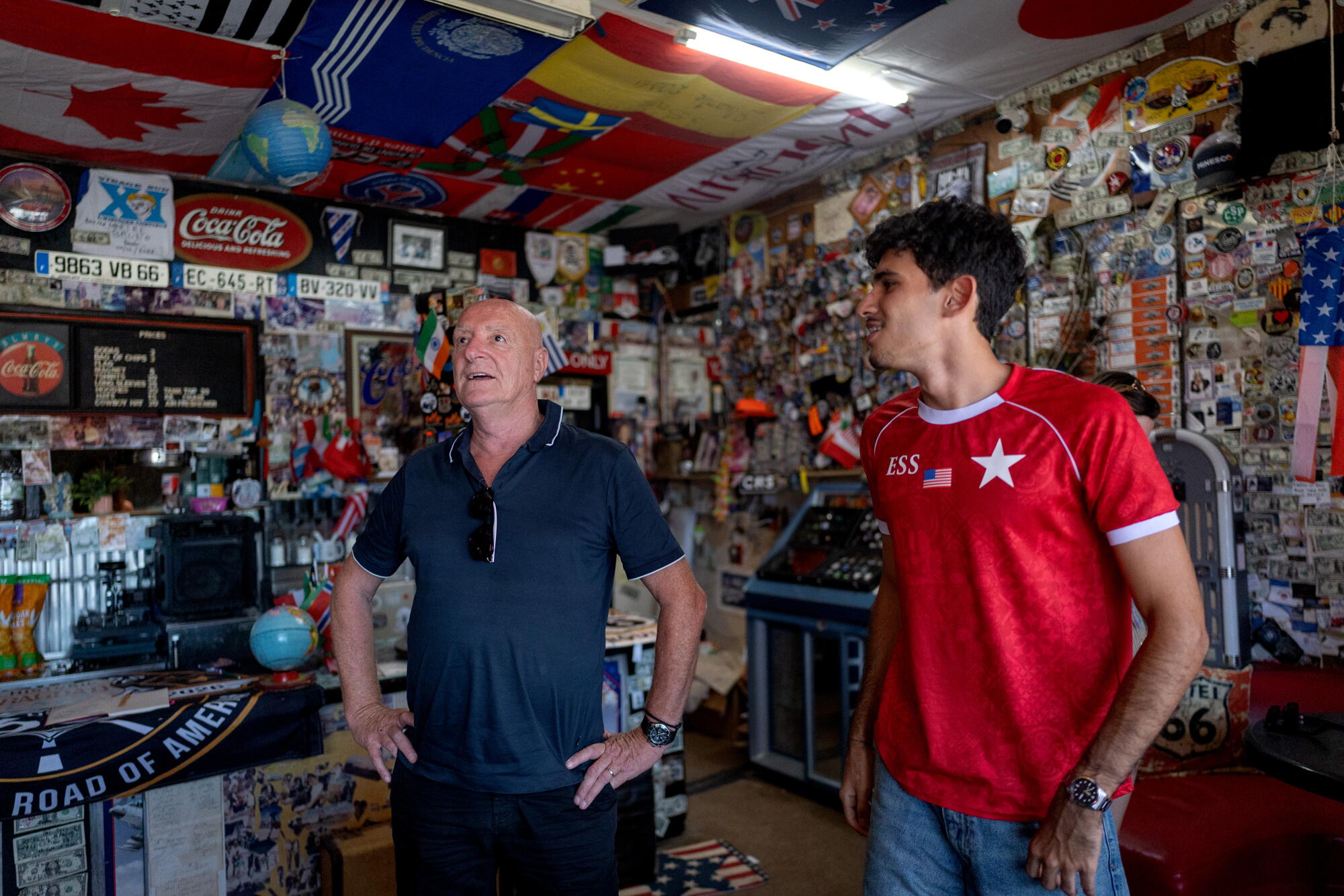 Two men look at the interior of the Bagdad Cafe on Route 66.