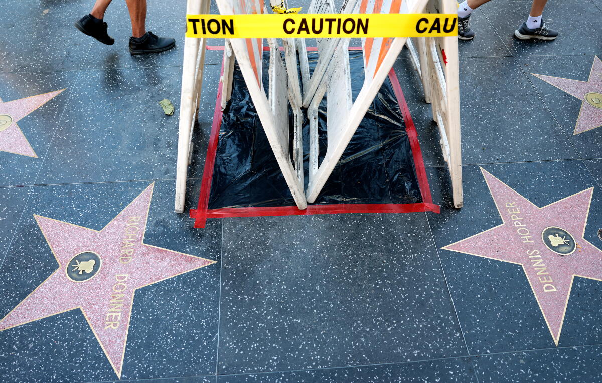 Tourists pass by Dolly Parton's star on the Hollywood Walk of Fame