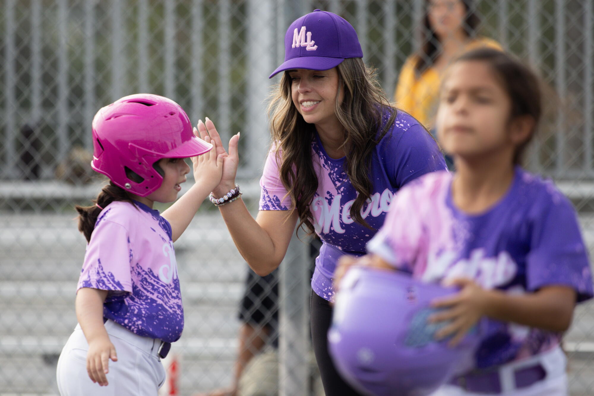 Odalys Valladares high-fives a Little Leaguer.