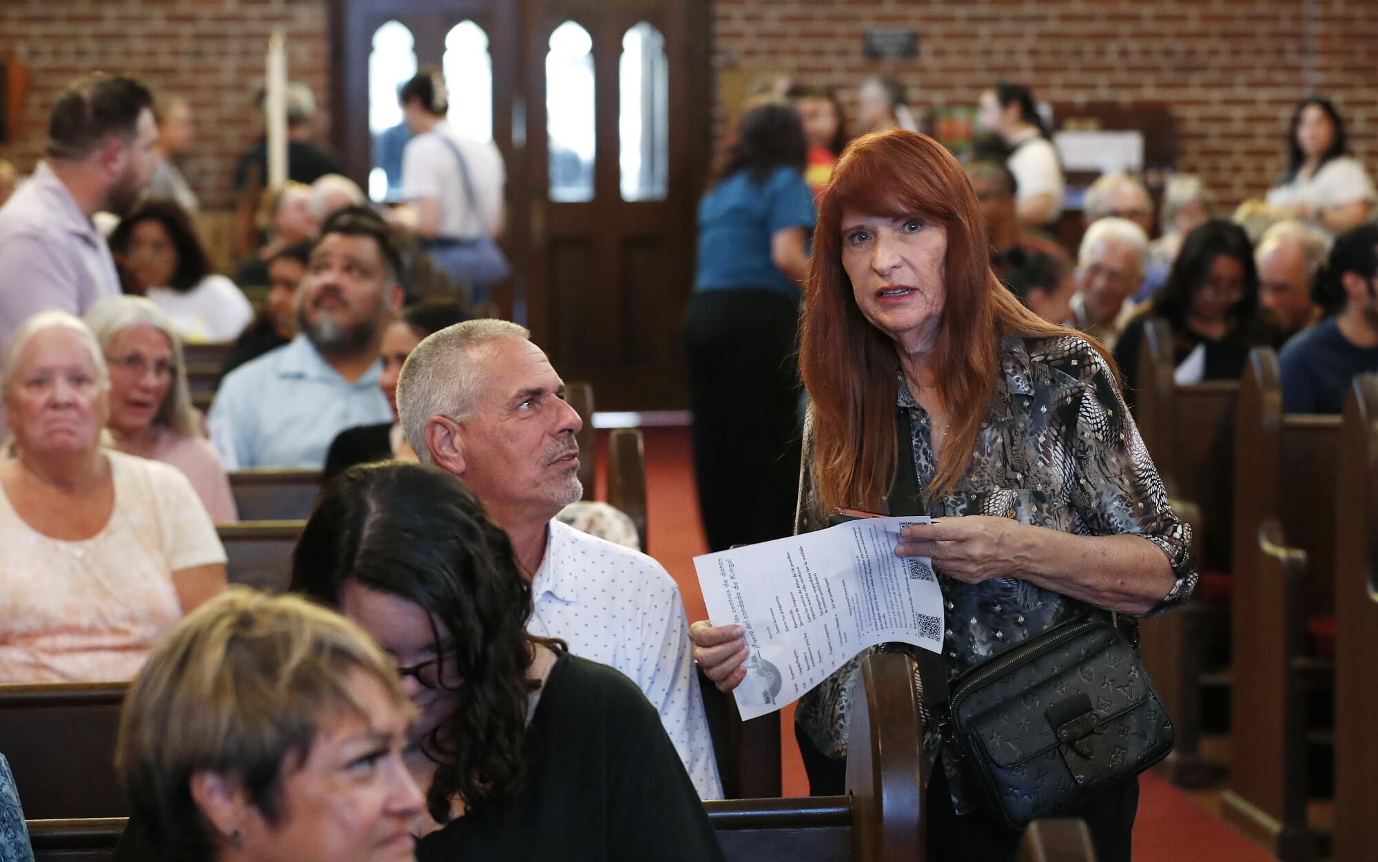 Hanford Mayor Mark Kairis speaks with coulcilwoman Kimber Regan during a town hall meeting in Hanford.