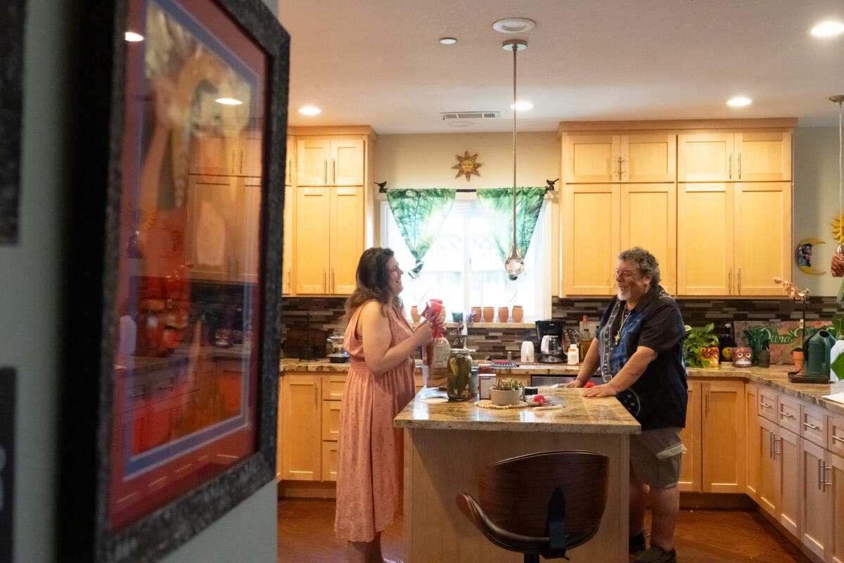 Rudy Ramirez and Sarah Lawlor chat in a kitchen