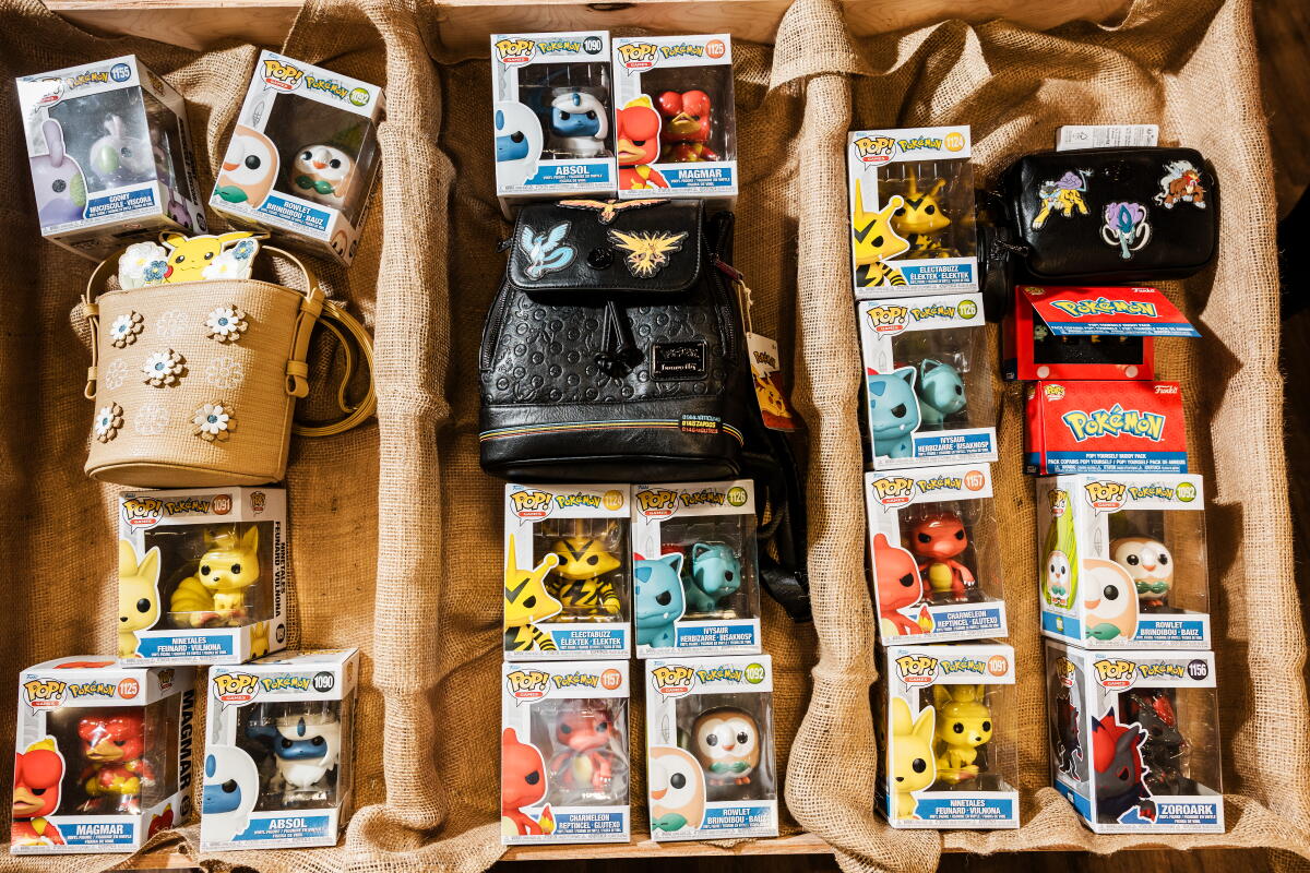 A collection of Funko Pop! figurines in their boxes, on display