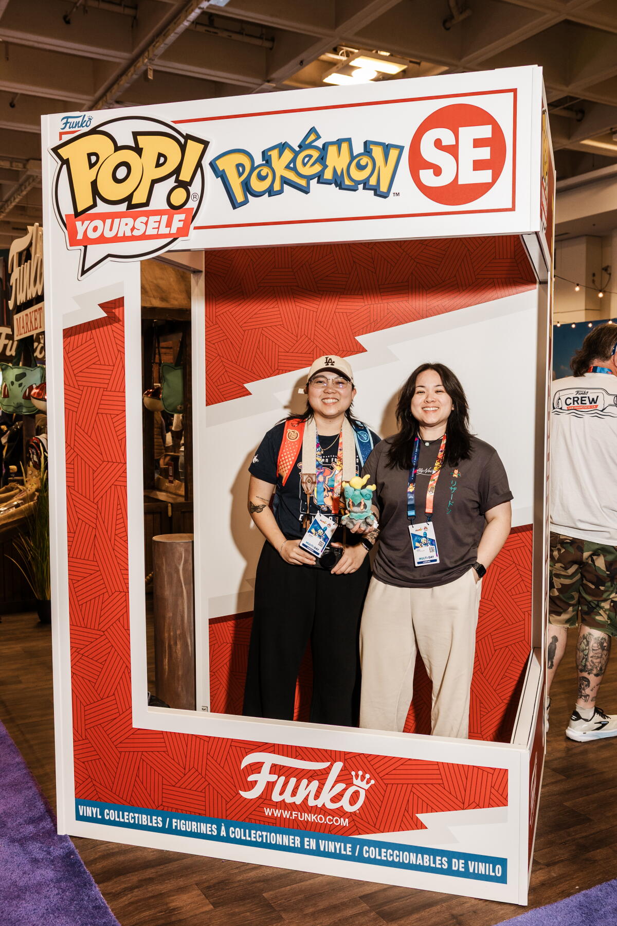 Convention-goers stand inside a life-size Funko toy box