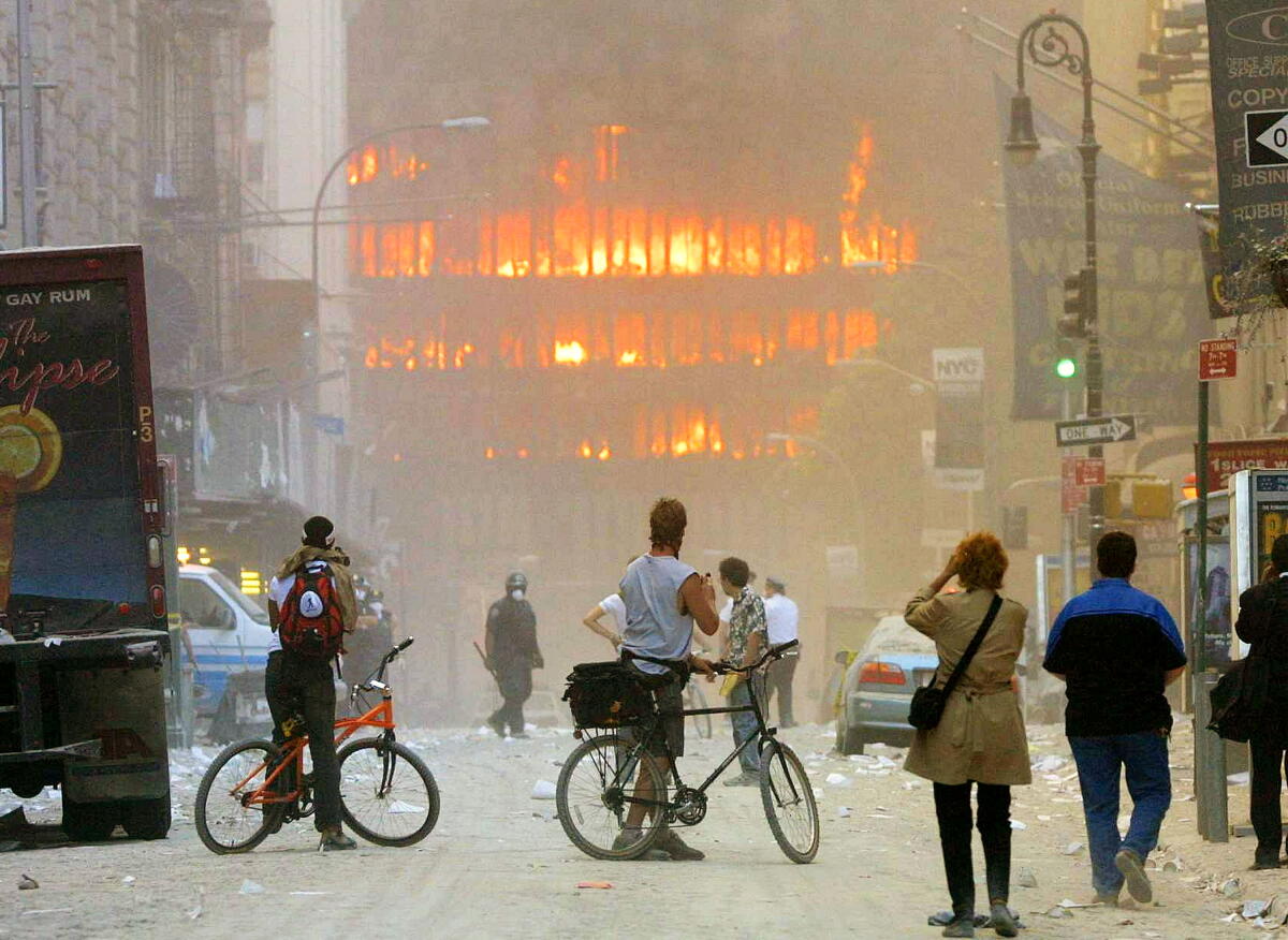 People walk in the street in the area where the World Trade Center buildings collapsed