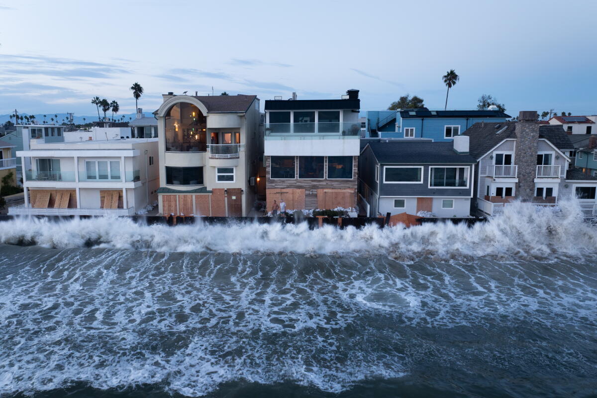 Waves combined with a 6 foot high tide batter the boardwalk on the Alamitos Peninsula in Long Beach