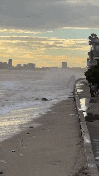 Massive waves crash along the Long Beach boardwalk