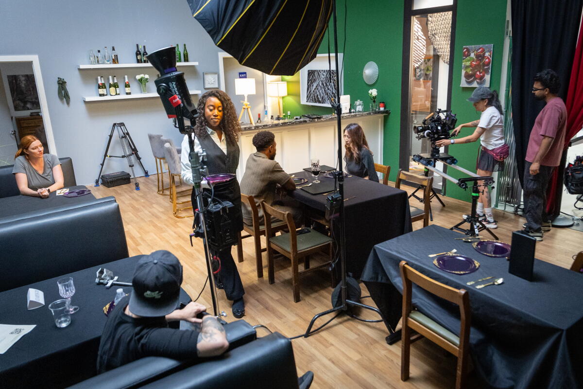 Filmmakers rehearse a scene in the restaurant set at Dhar Mann Studios.