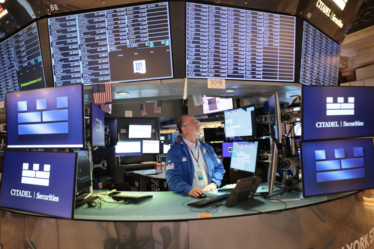 Traders work on the floor of the New York Stock Exchange during morning trading