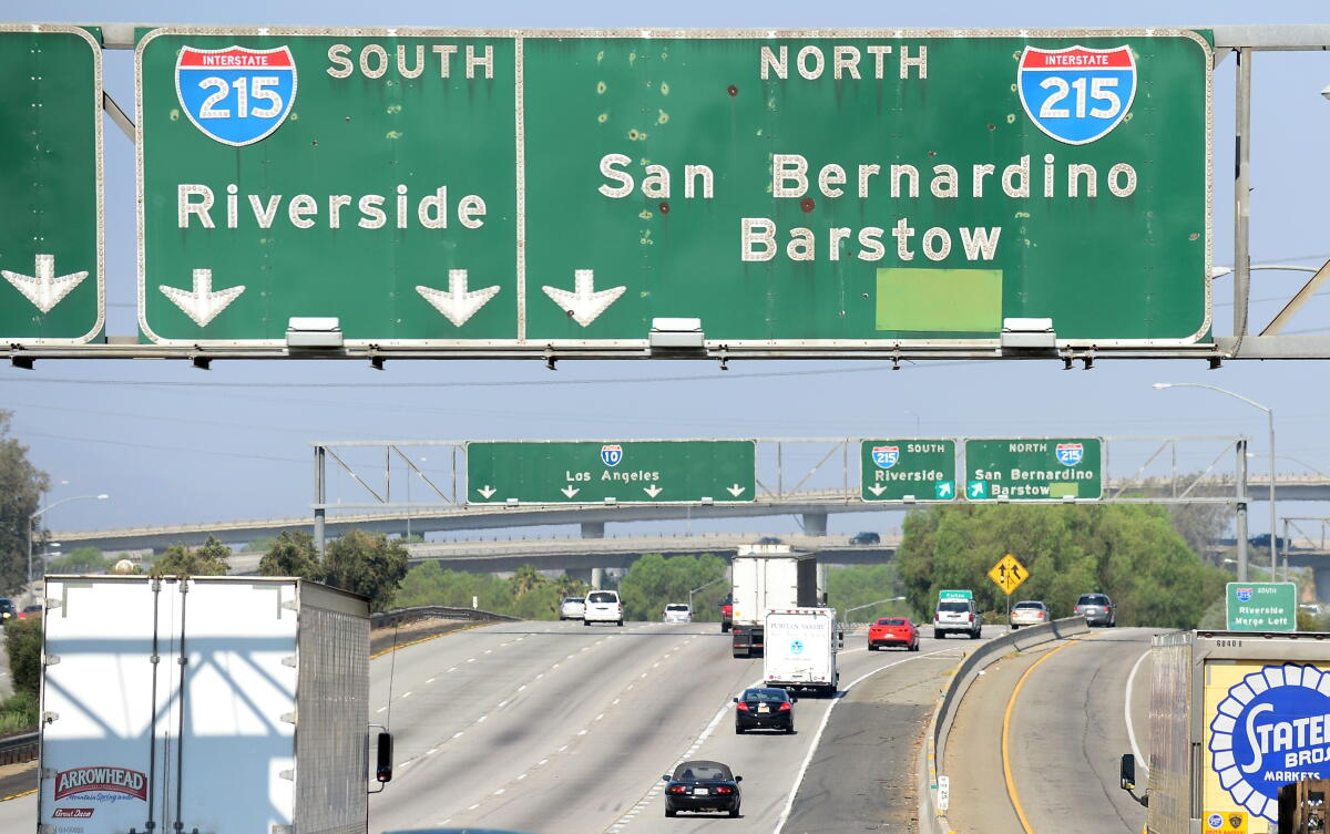 Freeway signs for the 215 point drivers toward Riverside and San Bernardino.
