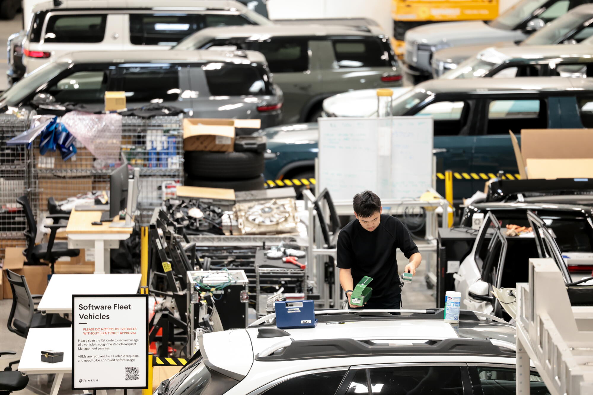 A person at work in the midst of vehicles