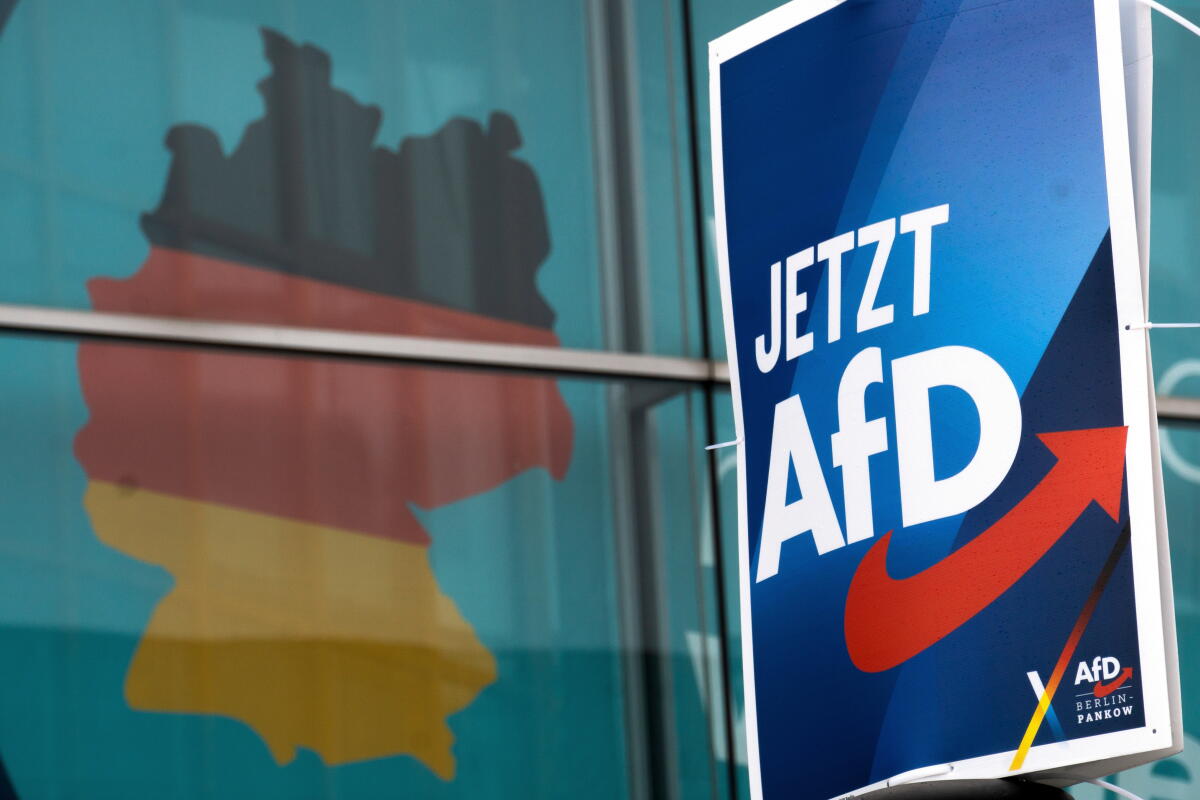 An election poster touts the far-right Alternative for Germany party, AfD, right, in Berlin in 2025. It reads "Now AfD."