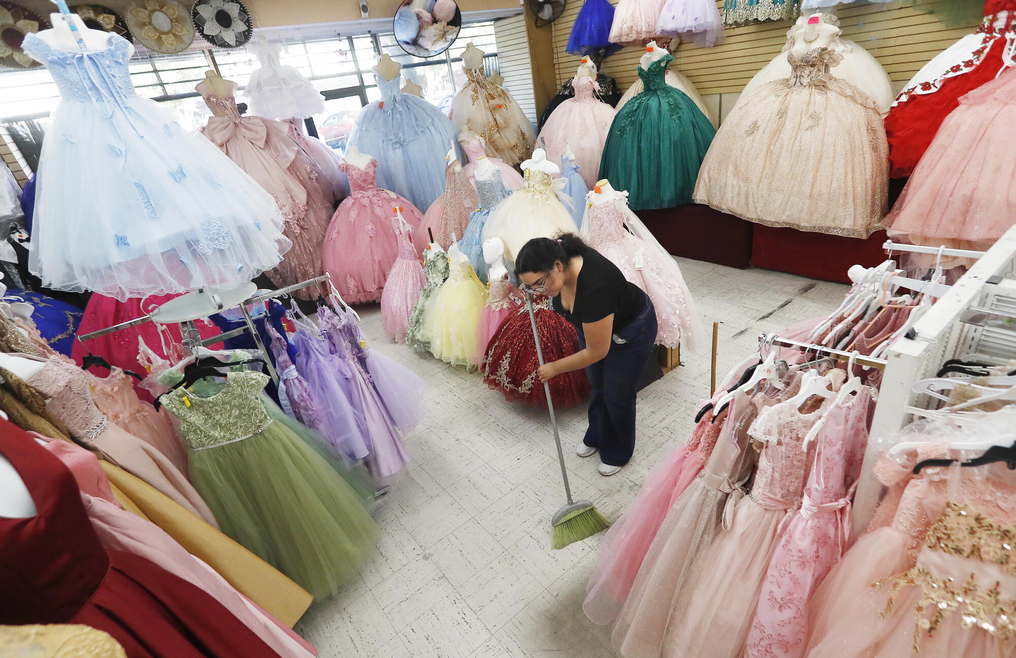Alexa Lopez sweeps up at a dress shop