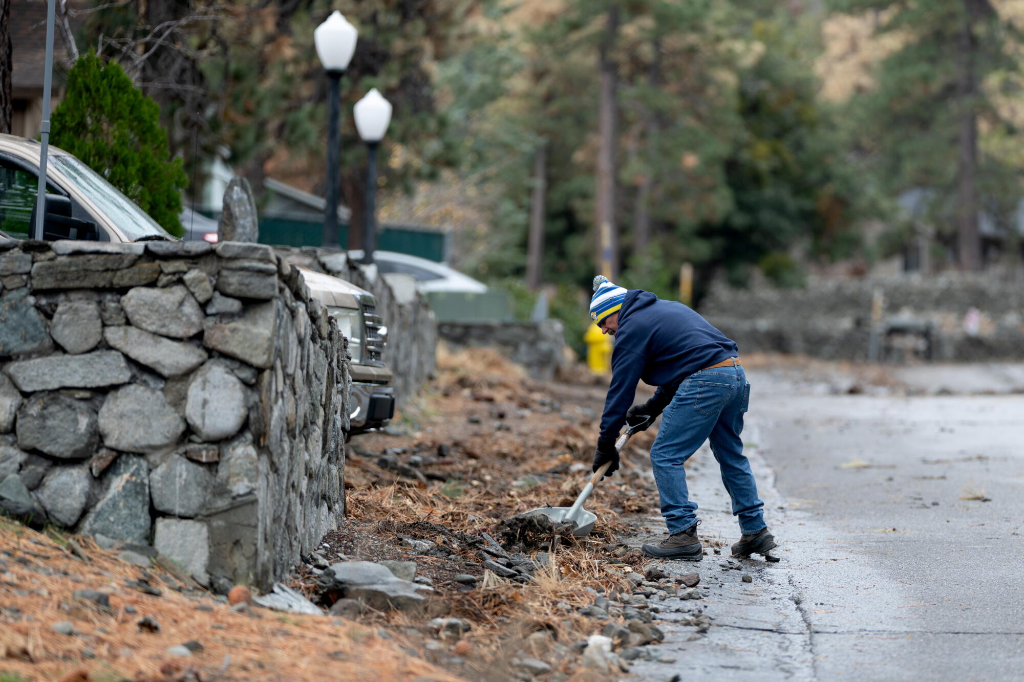 Resident Ed Kolar clears the area in front of his home in Wrightwood in December.